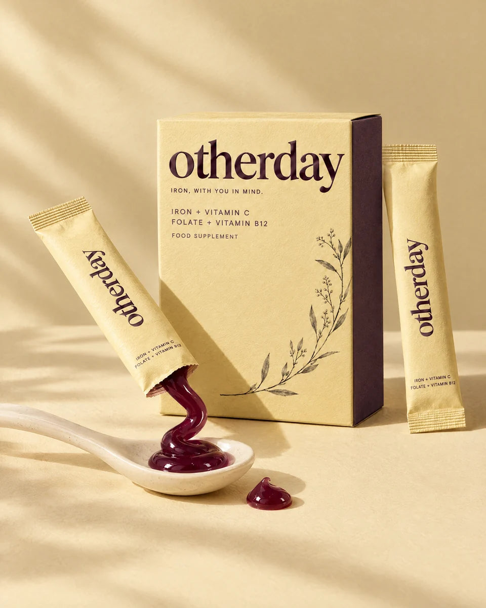 Illustration of an opened Otherday sachet with a glossy berry-coloured gel ribbon on a ceramic spoon